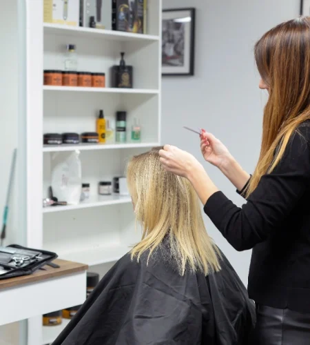 beautiful-brunette-working-as-hairdresser-cuts-ends-client-s-hair-beauty-salon